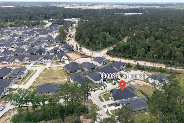 40003 Reef Heron St, Magnolia, TX 77354 - aerial overview of property's location with nearby suburban area and a heavily wooded area