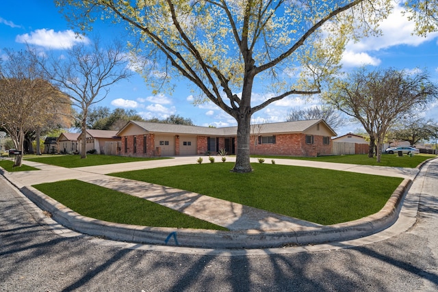 204 Hilltop Dr, Seguin, TX 78155 - ranch-style house featuring brick siding, a garage, a front lawn, and curved driveway