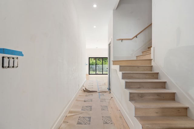 staircase featuring recessed lighting