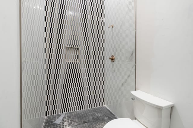 bathroom with toilet and a shower stall