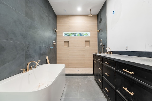 full bath featuring tiled shower, vanity, tile walls, and a freestanding tub
