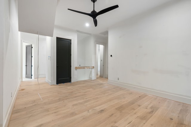 spare room featuring light wood-style flooring, baseboards, visible vents, and ceiling fan