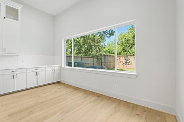 6536 Community Dr, West University Place, TX 77005 - empty room with baseboards and light wood finished floors