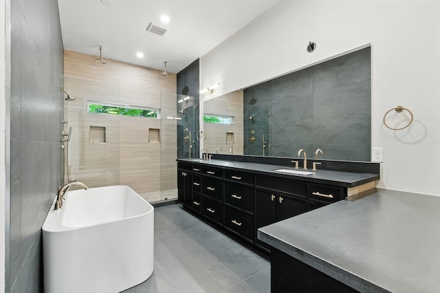 6536 Community Dr, West University Place, TX 77005 - full bathroom featuring a shower stall, double vanity, a freestanding bath, and tile walls