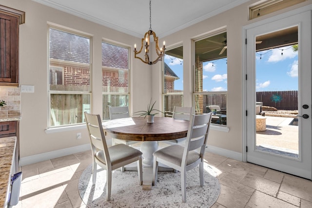 2316 Iron Ridge Ln, Friendswood, TX 77546 - dining area with crown molding, baseboards, stone tile flooring, and a notable chandelier