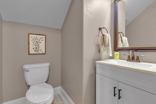 2316 Iron Ridge Ln, Friendswood, TX 77546 - bathroom featuring toilet, baseboards, vaulted ceiling, and vanity