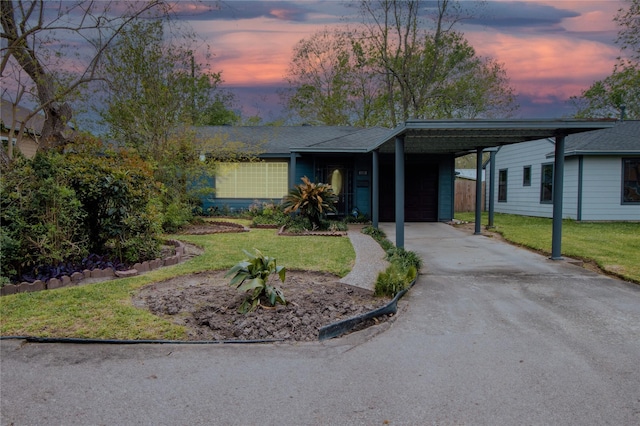 6038 Belcrest St, Houston, TX 77033 - single story home with asphalt driveway, a yard, a carport, and an attached garage