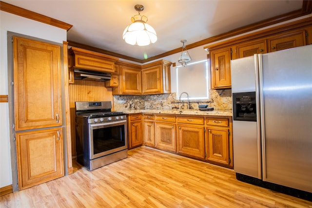 6038 Belcrest St, Houston, TX 77033 - kitchen featuring stainless steel appliances, range hood, brown cabinets, decorative backsplash, and a sink