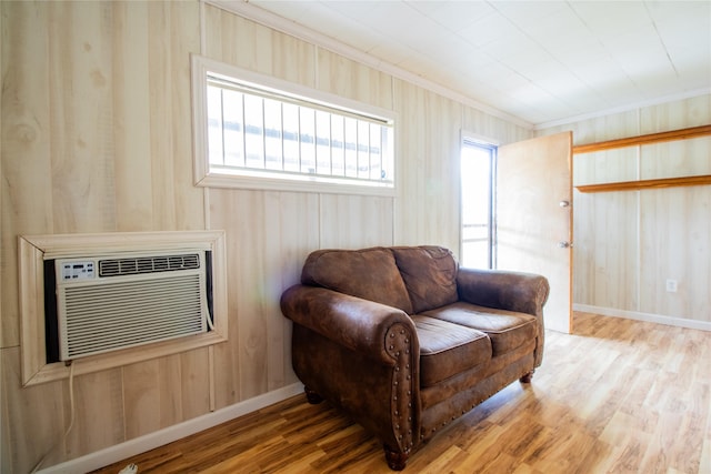 6038 Belcrest St, Houston, TX 77033 - sitting room with wood finished floors, baseboards, crown molding, and wood walls