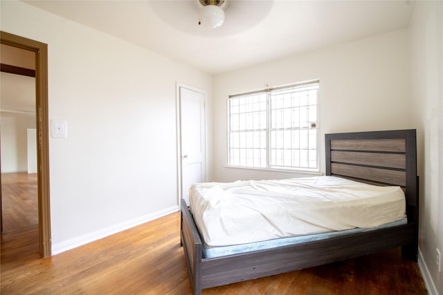 6038 Belcrest St, Houston, TX 77033 - bedroom with wood finished floors, baseboards, and ceiling fan