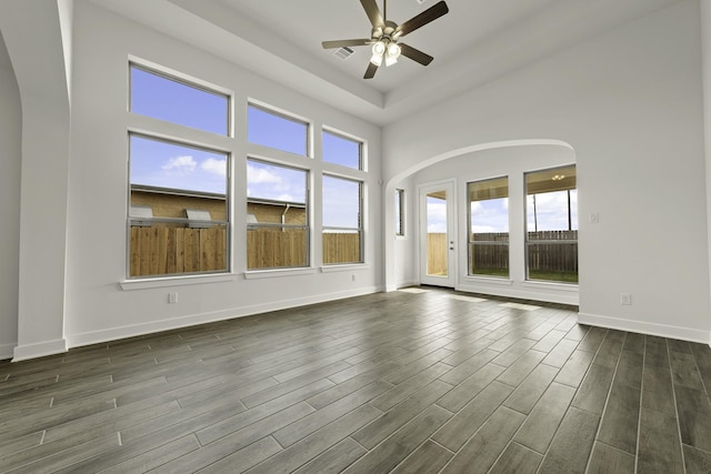 10403 Shining Dawn Way, Richmond, TX 77406 - empty room featuring ceiling fan, dark wood-style floors, baseboards, and arched walkways