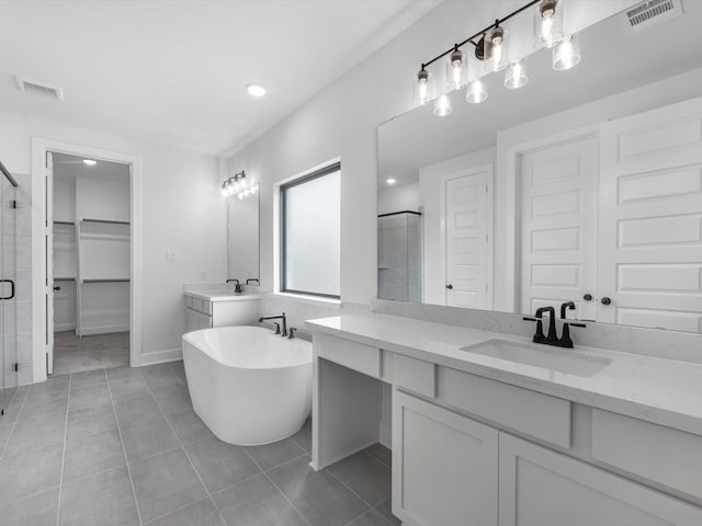 3193 Stingray Cove Dr, Katy, TX 77493 - bathroom with a stall shower, vanity, a freestanding tub, tile patterned flooring, and a spacious closet