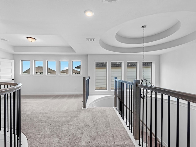 3193 Stingray Cove Dr, Katy, TX 77493 - hallway featuring a tray ceiling, an upstairs landing, carpet flooring, and recessed lighting