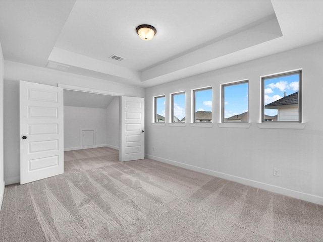 3193 Stingray Cove Dr, Katy, TX 77493 - unfurnished bedroom featuring a tray ceiling and light colored carpet