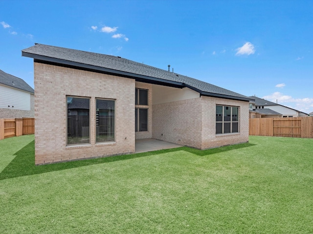 3193 Stingray Cove Dr, Katy, TX 77493 - rear view of house featuring a fenced backyard, brick siding, a patio, and a shingled roof