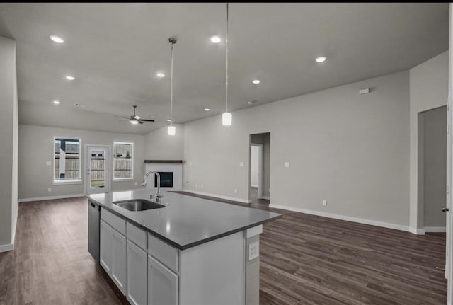 716 Ivory Creek Ct, Willis, TX 77378 - kitchen featuring a ceiling fan, open floor plan, a sink, and a fireplace