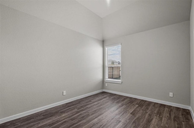 716 Ivory Creek Ct, Willis, TX 77378 - empty room featuring dark wood-type flooring, baseboards, and vaulted ceiling