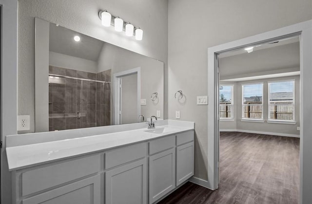 716 Ivory Creek Ct, Willis, TX 77378 - full bathroom featuring vanity, baseboards, a stall shower, and wood finished floors