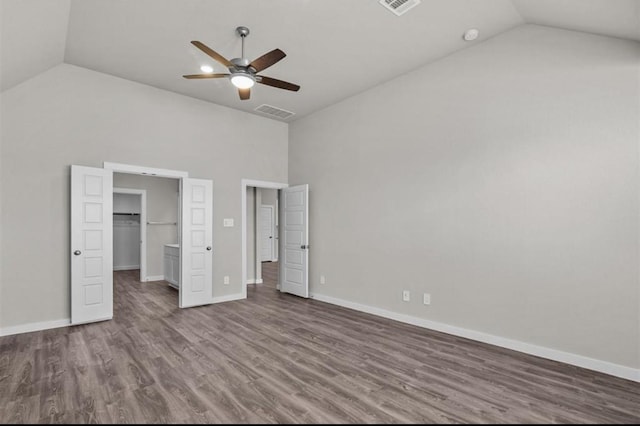 716 Ivory Creek Ct, Willis, TX 77378 - unfurnished bedroom featuring visible vents, baseboards, wood finished floors, and high vaulted ceiling
