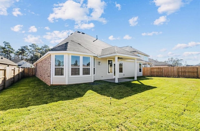716 Ivory Creek Ct, Willis, TX 77378 - back of property with a lawn, a patio, a ceiling fan, and a fenced backyard