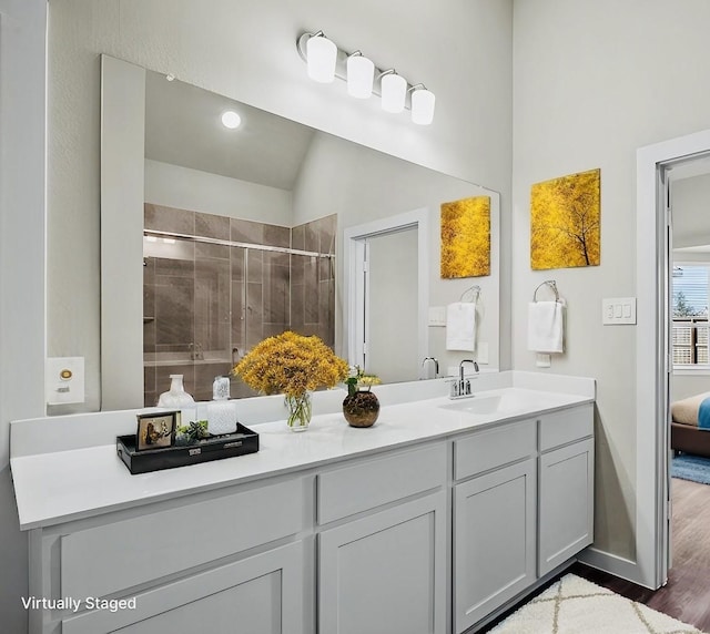 716 Ivory Creek Ct, Willis, TX 77378 - bathroom with vanity, baseboards, a shower stall, wood finished floors, and ensuite bathroom