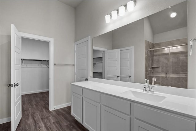 716 Ivory Creek Ct, Willis, TX 77378 - bathroom featuring vanity, baseboards, a shower stall, and wood finished floors