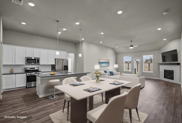 716 Ivory Creek Ct, Willis, TX 77378 - dining area with recessed lighting, a ceiling fan, lofted ceiling, visible vents, and dark wood-style floors