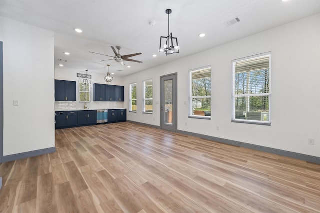 200 Canary St, Point Blank, TX 77364 - unfurnished living room featuring recessed lighting, a ceiling fan, a chandelier, light wood-style floors, and baseboards