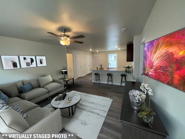 7981 Cinderella St, Houston, TX 77028 - living area with dark wood finished floors, ceiling fan, and baseboards