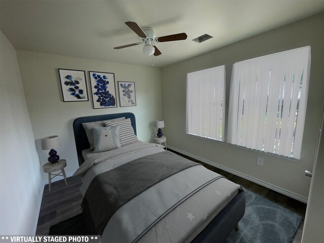 7981 Cinderella St, Houston, TX 77028 - bedroom featuring baseboards, wood finished floors, and a ceiling fan