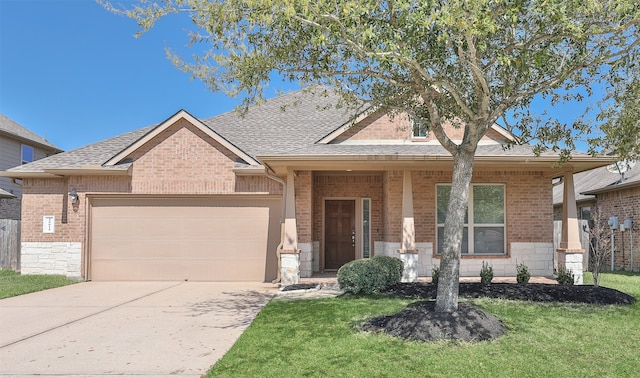view of front of house with concrete driveway, brick siding, a front lawn, and an attached garage