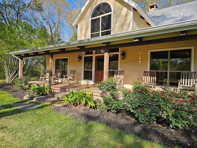 rear view of house featuring a porch