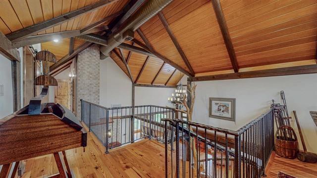 staircase featuring vaulted ceiling with beams, wood finished floors, wood ceiling, and a chandelier