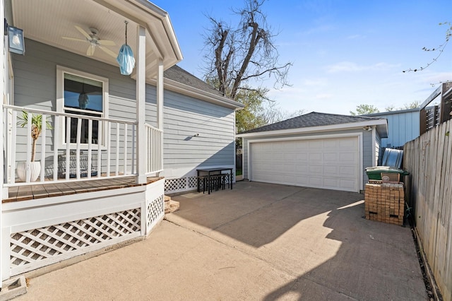 exterior space featuring an outdoor structure, covered porch, ceiling fan, and a detached garage