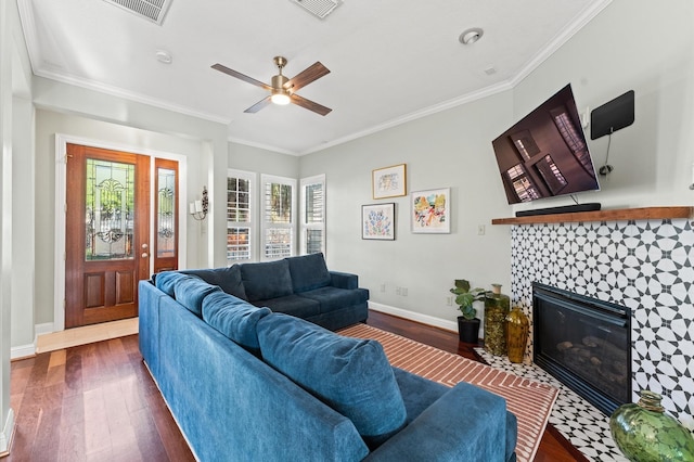 living area featuring dark wood-style flooring, ornamental molding, and plenty of natural light
