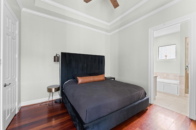 bedroom featuring ornamental molding, baseboards, connected bathroom, a ceiling fan, and wood finished floors