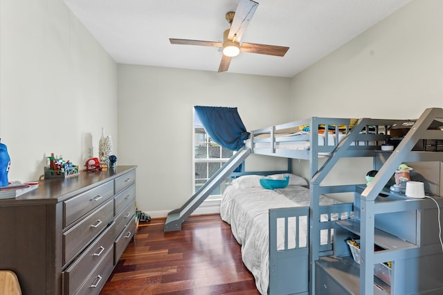 bedroom with baseboards, ceiling fan, and dark wood finished floors