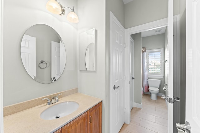 bathroom featuring toilet and vanity