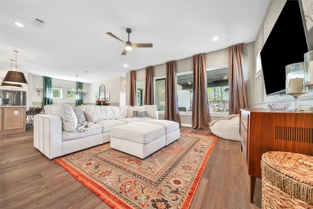 325 Bromley Square Dr, Montgomery, TX 77316 - living room with ceiling fan with notable chandelier, wood finished floors, visible vents, and recessed lighting