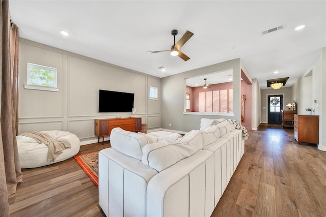 325 Bromley Square Dr, Montgomery, TX 77316 - living area with a wealth of natural light, visible vents, ceiling fan, and wood finished floors
