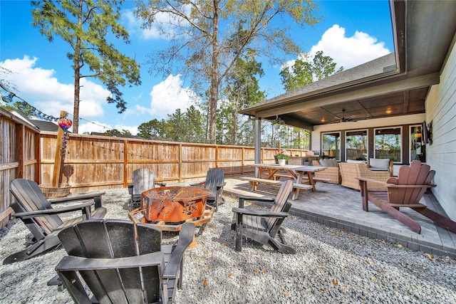 325 Bromley Square Dr, Montgomery, TX 77316 - view of patio featuring a fire pit, a fenced backyard, outdoor dining area, and a ceiling fan