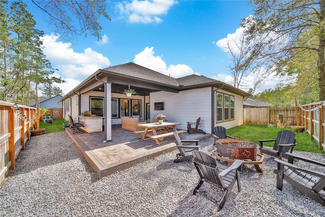 325 Bromley Square Dr, Montgomery, TX 77316 - back of property with a patio area, a fenced backyard, and an outdoor fire pit
