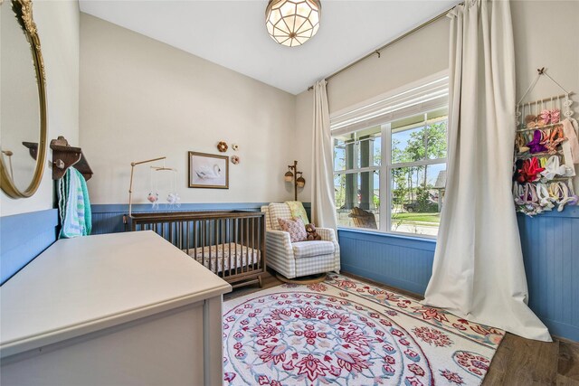 325 Bromley Square Dr, Montgomery, TX 77316 - bedroom featuring a nursery area and wood finished floors