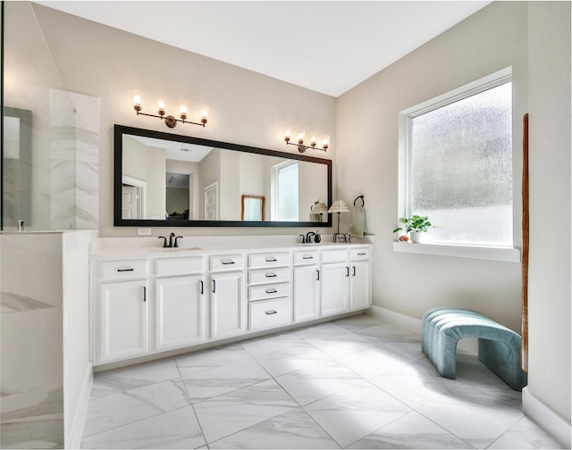 325 Bromley Square Dr, Montgomery, TX 77316 - bathroom with double vanity, marble finish floor, a sink, and baseboards