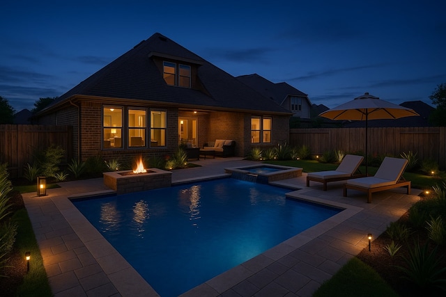 23306 Oakheath Pines Pl, Katy, TX 77493 - rear view of property featuring brick siding, a patio area, an outdoor living space with a fire pit, a pool with connected hot tub, and a fenced backyard