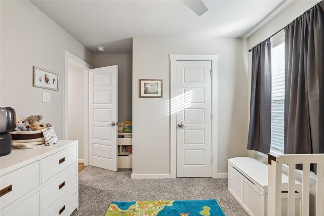 bedroom featuring baseboards and light colored carpet