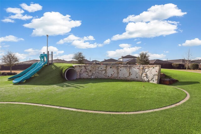 view of community with a yard and a playground