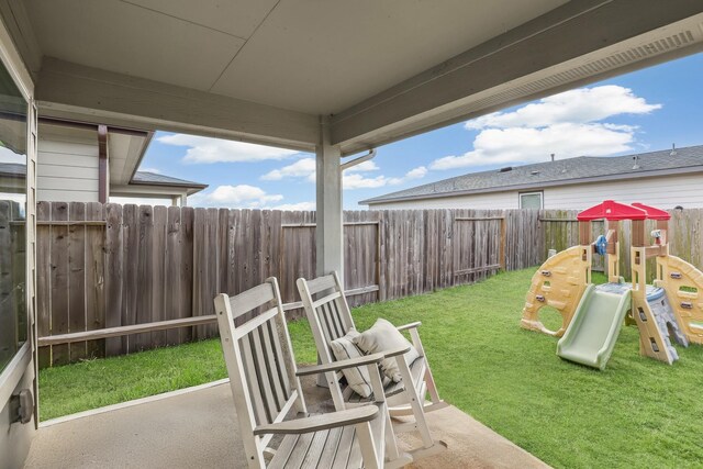 view of patio with a fenced backyard and a playground