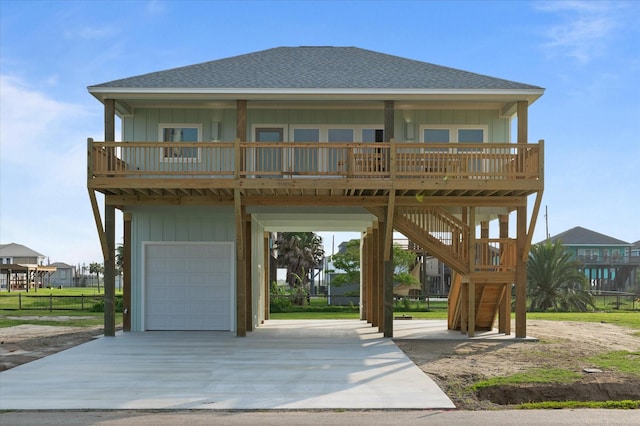 view of front of property with roof with shingles, concrete driveway, board and batten siding, and an attached garage