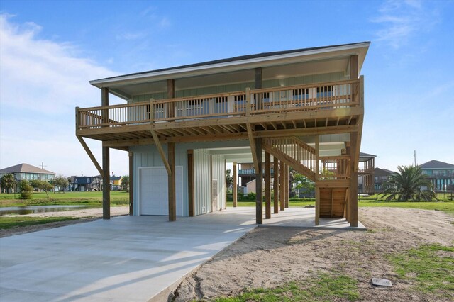 view of front facade with a carport, a deck with water view, and board and batten siding